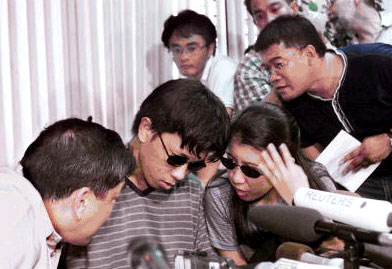 Onel de Guzman and his sister Irene in front of the world's media
