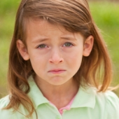 Young girl crying. Image from Shutterstock