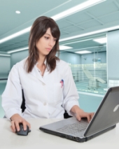 Hospital worker using computer. Image courtesy Shutterstock