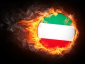 Iran flag in flames. Image courtesy of Shutterstock