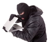 Burglar with computer. Image courtesy of Shutterstock