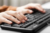 Fingers at keyboard, courtesy of Shutterstock