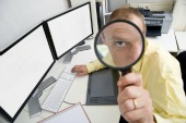 Man with magnifying glass, courtesy of Shutterstock