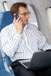 Man on phone in plane, courtesy of Shutterstock