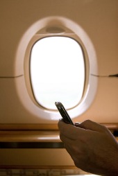 Phone and plane window, courtesy of Shutterstock