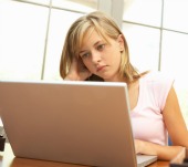 Teen on computer. Image from Shutterstock