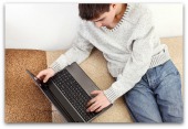 Teenager with computer. Image courtesy of Shutterstock