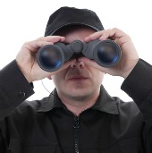 Man spying. Image courtesy of Shutterstock