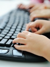 Child hands keyboard. Image courtesy of Shutterstock