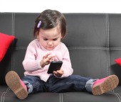 Child on smartphone. Image courtesy of Shutterstock.