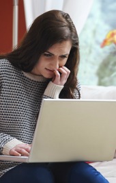 Teenager on computer. Image courtesy of Shutterstock.