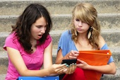 Kids on phone, courtesy of Shutterstock