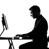 Image of man at desk courtesy of Shutterstock