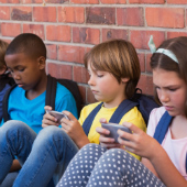 Children with mobile phones, image courtesy of Shutterstock