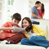 Children playing on device, image courtesy of Shutterstock