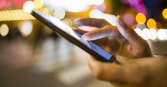 Woman using phone. Image courtesy of Shutterstock